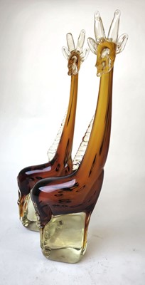 Lot 256 - A pair of hand-blown amber glass figures...