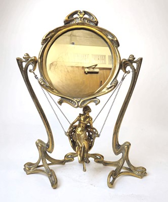 Lot 305 - An Art Nouveau brass table-top mirror, the...