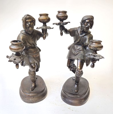 Lot 309 - A pair of bronze figural candlesticks modelled...