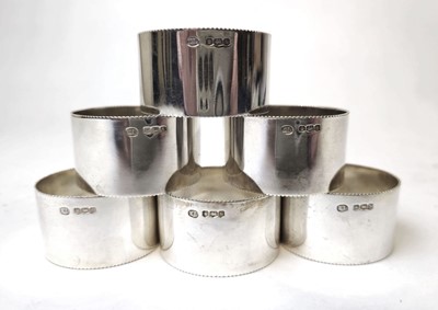 Lot 406 - A set of six Elizabeth II silver napkin rings...