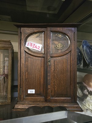 Lot 303 - A 20th century oak smokers cabinet with two...