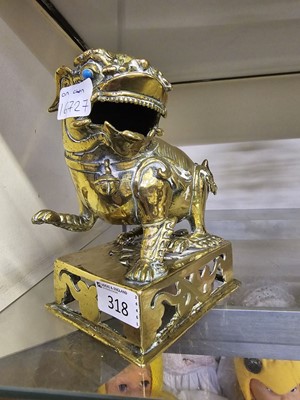 Lot 318 - An eastern style brass model of a foo dog on base