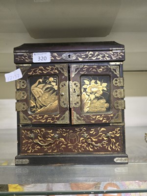 Lot 320 - An oriental lacquered desk cabinet with bird...