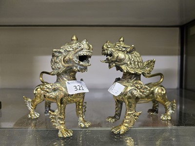 Lot 321 - Two 20th century eastern brass models of foo dogs