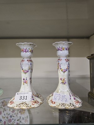 Lot 331 - A pair of ceramic candlesticks with floral...