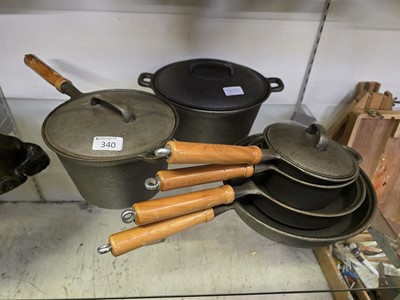 Lot 340 - An assortment of six cast iron pots and pans