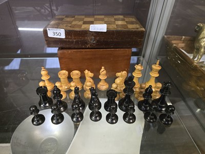 Lot 350 - A boxed set of chess pieces along with a chess...