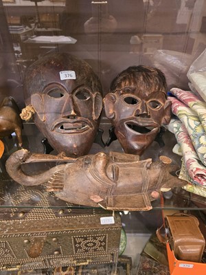 Lot 376 - Two carved African wooden masks along with...