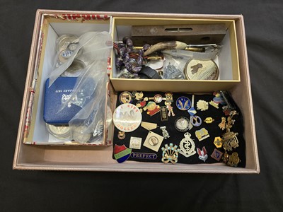 Lot 394 - A box containing badges, spirit level, costume...