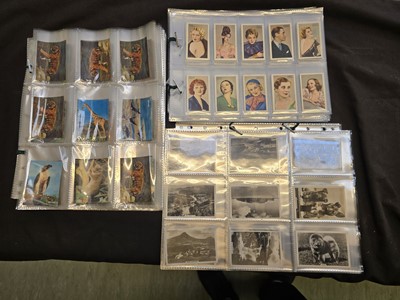 Lot 399 - A box containing a quantity of cigarette cards,...