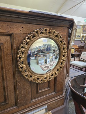 Lot 35 - A circular ornate gilt framed convex wall mirror