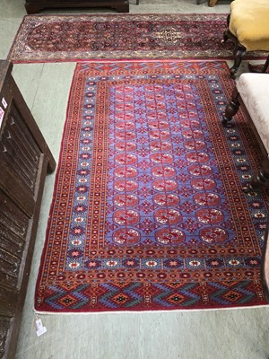 Lot 39 - An eastern rectangular red ground rug