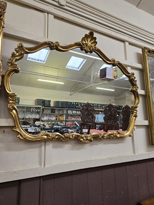 Lot 49 - A reproduction ornate gilt framed wall mirror