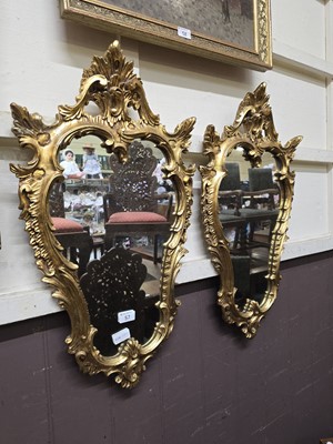 Lot 57 - A pair of reproduction ornate gilt framed wall...