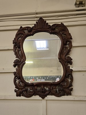 Lot 70 - A reproduction carved oak wall mirror