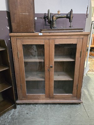 Lot 73 - A waxed pine glazed two door cabinet