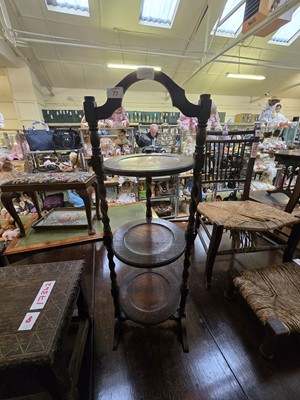 Lot 77 - An early 20th century oak three tier cake stand