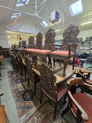 Lot 80 - A carved teak extending dining table together...