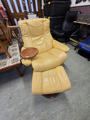 Lot 122 - A yellow reclining swivel chair with matching...