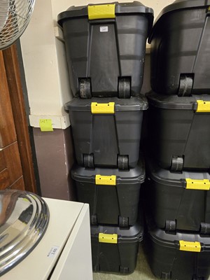 Lot 147 - A set of four large black lidded PVC storage...