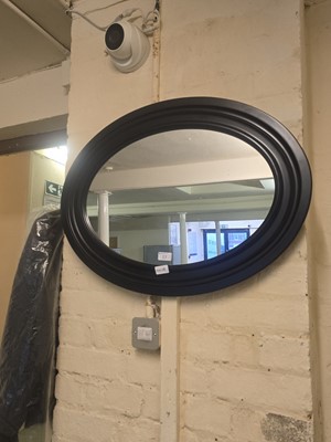 Lot 17 - A circular black framed wall mirror