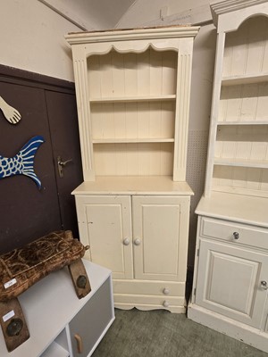 Lot 22 - A cream painted dresser having plate rack to...