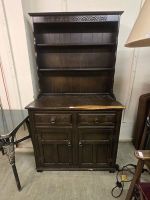 Lot 27 - A stained wooden dresser having plate rack to...