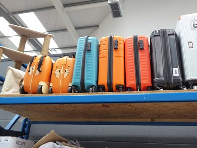 Lot 3218 - Four mini hard shelled suitcases plus two ride...