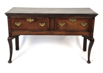 Lot 13 - A Georgian oak dresser base with two drawers...