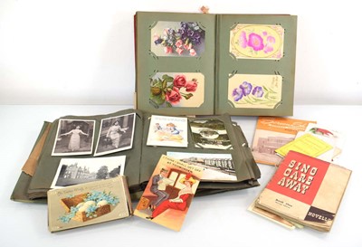 Lot 116 - Two albums of postcards including greetings...