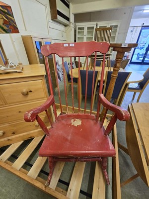 Lot 35 - A red painted spindle back rocking chair