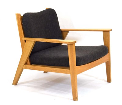 Lot 52 - A contemporary oak framed armchair with loose...