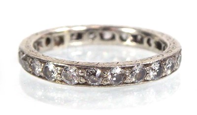 Lot 517 - A white metal eternity ring set small diamonds...