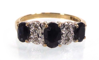 Lot 524 - A 9ct yellow gold ring set three graduated...