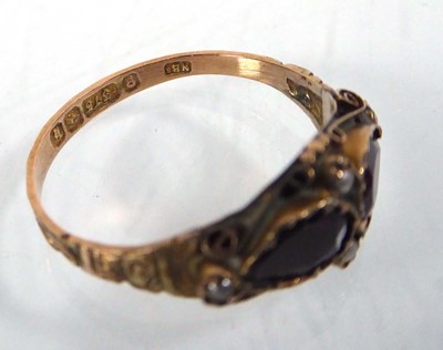 Lot 542 - An Edwardian 9ct yellow gold ring set two...