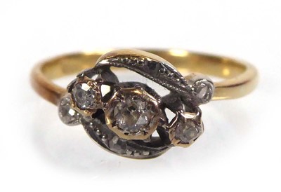 Lot 544 - An 18ct yellow gold crossover ring set three...