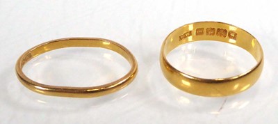 Lot 547 - Two 22ct yellow gold wedding bands, London...