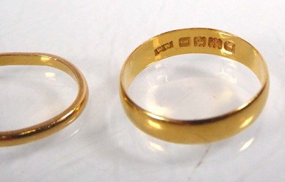 Lot 547 - Two 22ct yellow gold wedding bands, London...