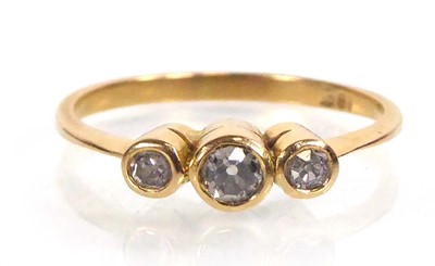 Lot 555 - An 18ct yellow gold ring set three small...