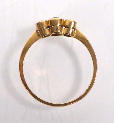 Lot 555 - An 18ct yellow gold ring set three small...