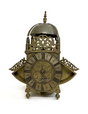 Lot 28 - A brass skeleton clock striking on a bell, the...