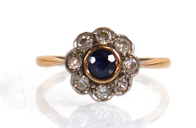 Lot 567 - A yellow metal cluster ring set sapphire and...