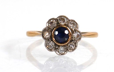 Lot 567 - A yellow metal cluster ring set sapphire and...