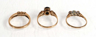 Lot 575 - A 9ct yellow gold ring set diamond and two...