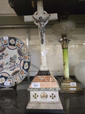 Lot 304 - A carved stonework crucifix with emblems...