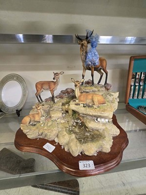 Lot 323 - A moulded figural group of family of deer on...