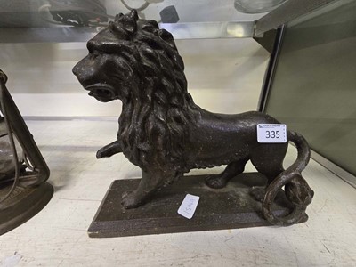 Lot 335 - A 20th century cast metal model of a lion on...