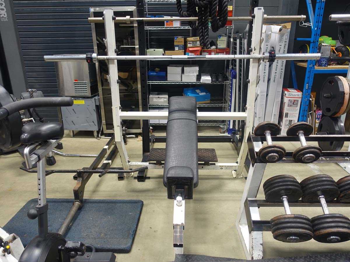 Lot 3009 - Incline bench plus Olympic bar and spotting plate