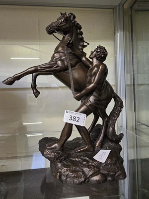 Lot 382 - A cast resin model of rearing horse and rider