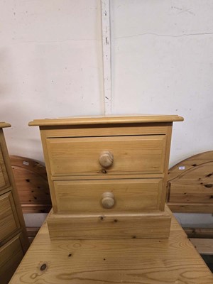 Lot 30 - A modern pine bedside chest of two drawers